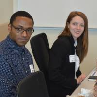 Two alumni sitting at a table at the 30 Minute Mentors Event